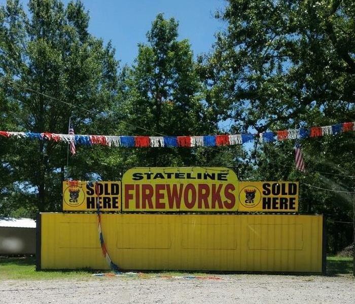 A firework stand on the side of the road