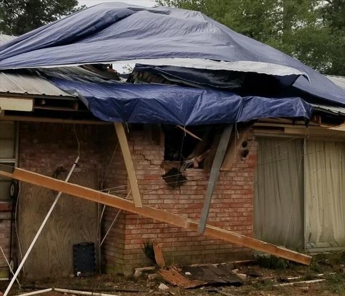 A tree had fallen on a house after a storm