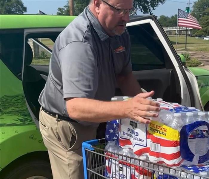SERVPRO employee donating water