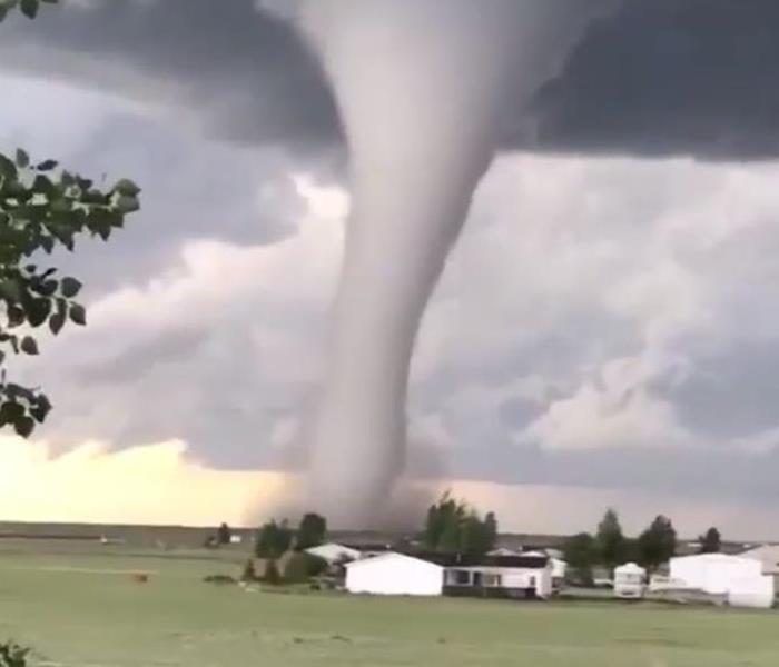 tornado funnel heading toward a house
